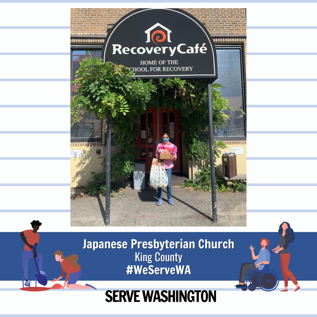 image of woman wearing a mask holding bags of donated items standing at store front of recovery cafe
