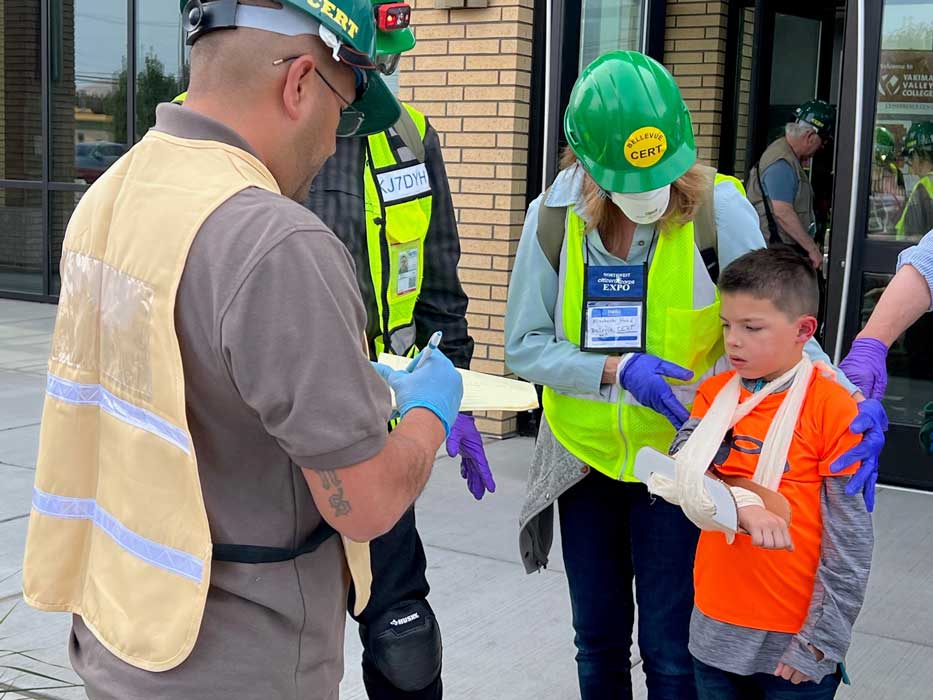 CERT members talking to a child with a sling on his arm